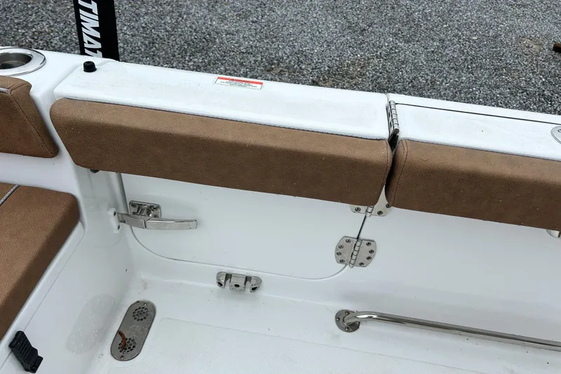 Slide: The Image of Interior view of 2025 Sea Hunt Ultra 265 SE boat with brown cushioned seating. - 17