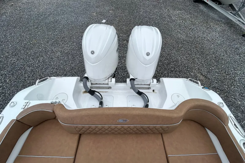 Slide: The Image of 2025 Sea Hunt Ultra 265 SE boat with dual outboard engines and tan seating. - 18