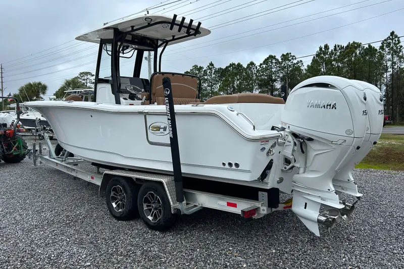 Slide: The Image of 2025 Sea Hunt Ultra 265 SE boat on trailer with dual Yamaha engines. - 3
