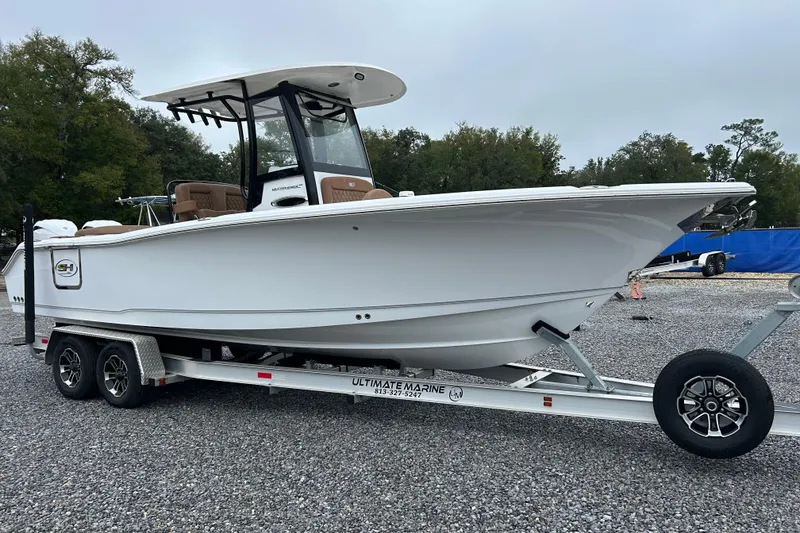 Slide: The Image of 2025 Sea Hunt Ultra 265 SE boat on trailer, parked outdoors. - 7