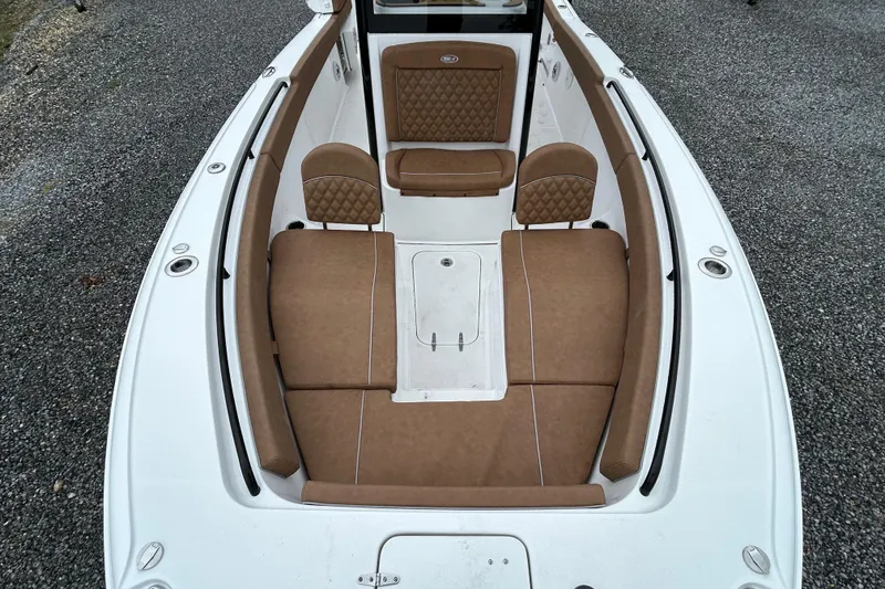 Slide: The Image of 2025 Sea Hunt Ultra 265 SE boat interior with brown cushioned seating. - 8