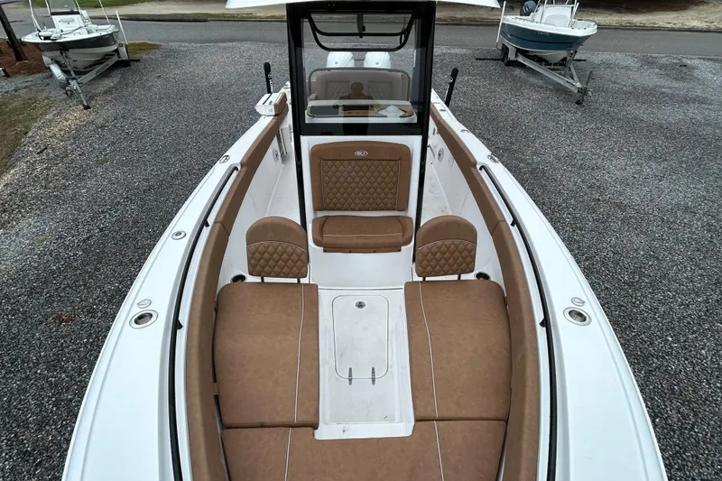 Slide: The Image of 2025 Sea Hunt Ultra 265 SE boat with tan seating and spacious deck. - 9