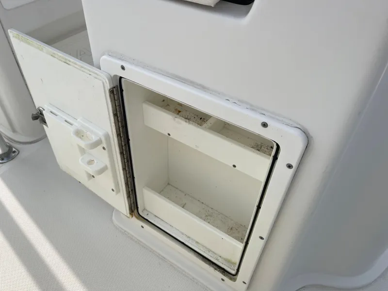 Slide: The Image of Open storage compartment on a 2015 Sea Hunt Ultra 234 boat. - 18