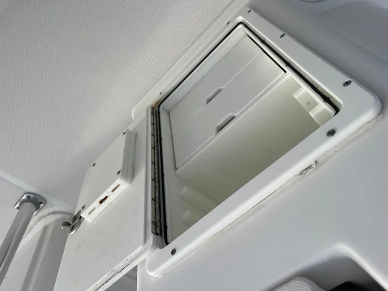 Slide: The Image of Open storage compartment on a 2015 Sea Hunt Ultra 234 boat. - 19