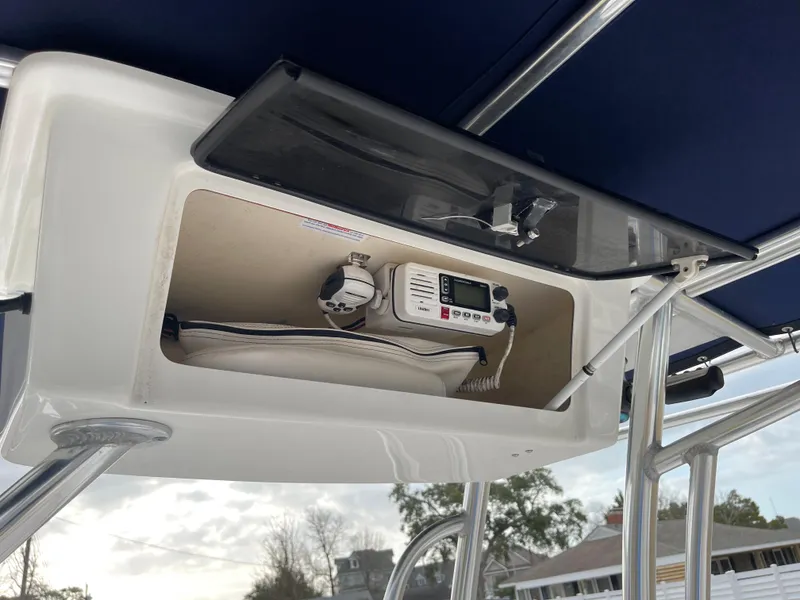 Slide: The Image of 2015 Sea Hunt Ultra 234 boat compartment with electronics. - 22