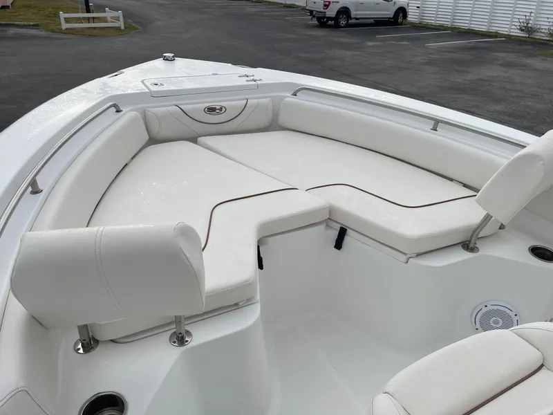Slide: The Image of Interior view of a 2015 Sea Hunt Ultra 234 boat with white seating. - 28