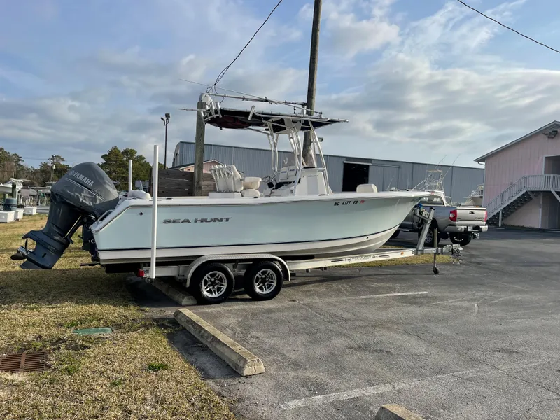 Slide: The Image of 2015 Sea Hunt Ultra 234 boat parked on trailer outdoors. - 6