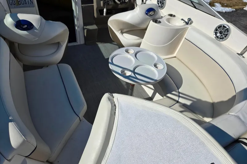 Slide: The Image of 2007 Rinker 246 Captiva Cuddy boat interior with seating and cup holders. - 11