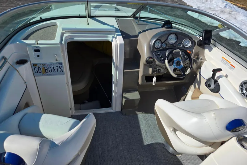 Slide: The Image of 2007 Rinker 246 Captiva Cuddy boat interior with steering wheel and seating. - 12