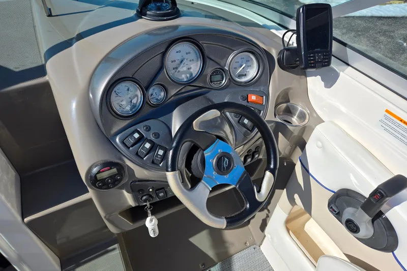 Slide: The Image of 2007 Rinker 246 Captiva Cuddy dashboard with steering wheel and instrument panel. - 13