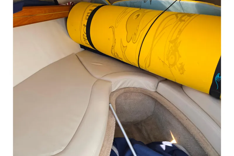Slide: The Image of 2007 Rinker 246 Captiva Cuddy interior with yellow inflatable tube on beige seating. - 16
