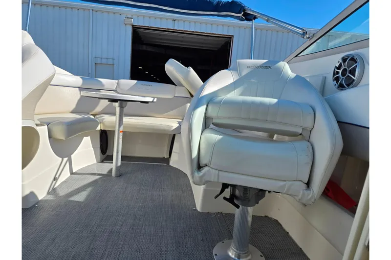 Slide: The Image of 2007 Rinker 246 Captiva Cuddy boat interior with seating and table. - 19