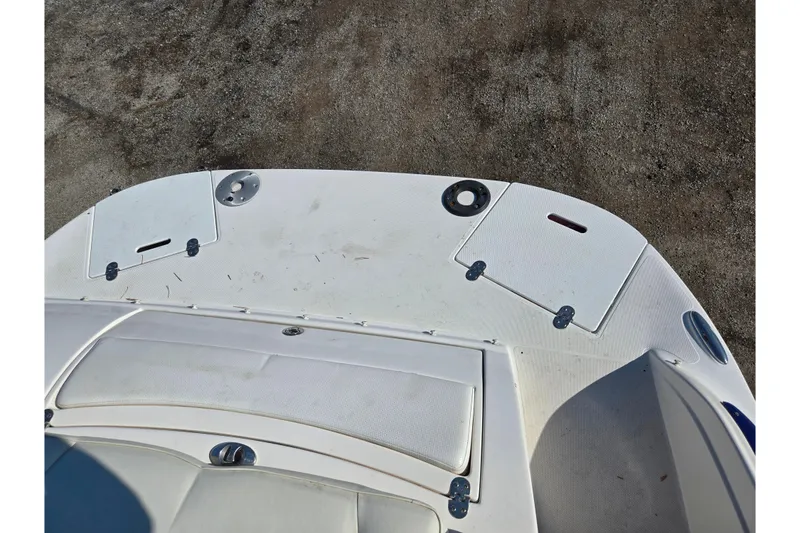 Slide: The Image of 2007 Rinker 246 Captiva Cuddy boat deck, featuring storage compartments and seating area. - 25