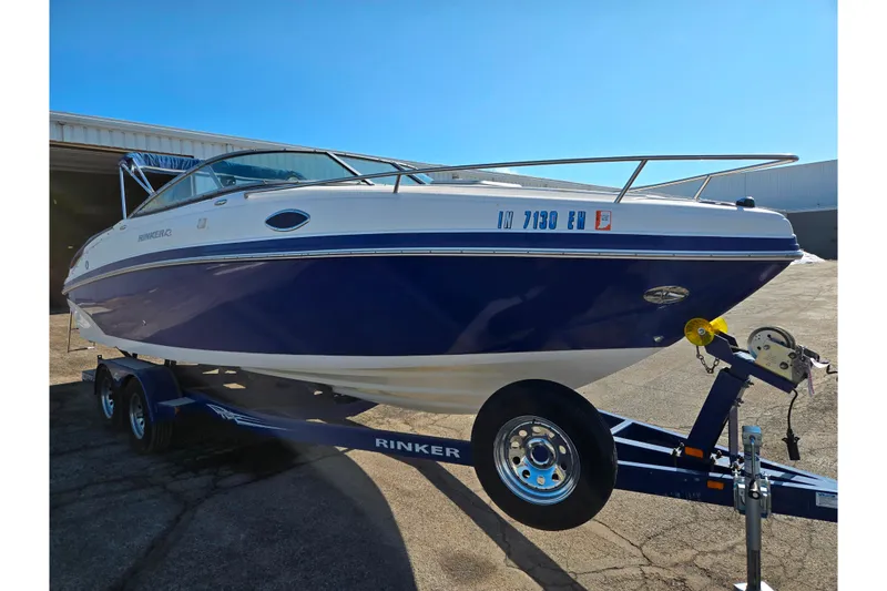 Slide: The Image of 2007 Rinker 246 Captiva Cuddy boat on trailer, blue and white exterior. - 5