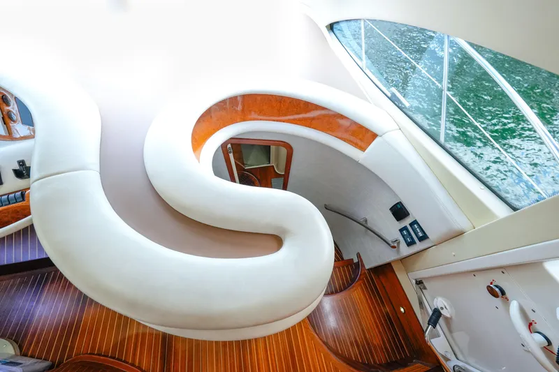 Slide: The Image of Luxurious interior of 2007 Azimut 68E yacht with elegant curved seating and wooden flooring. - 25