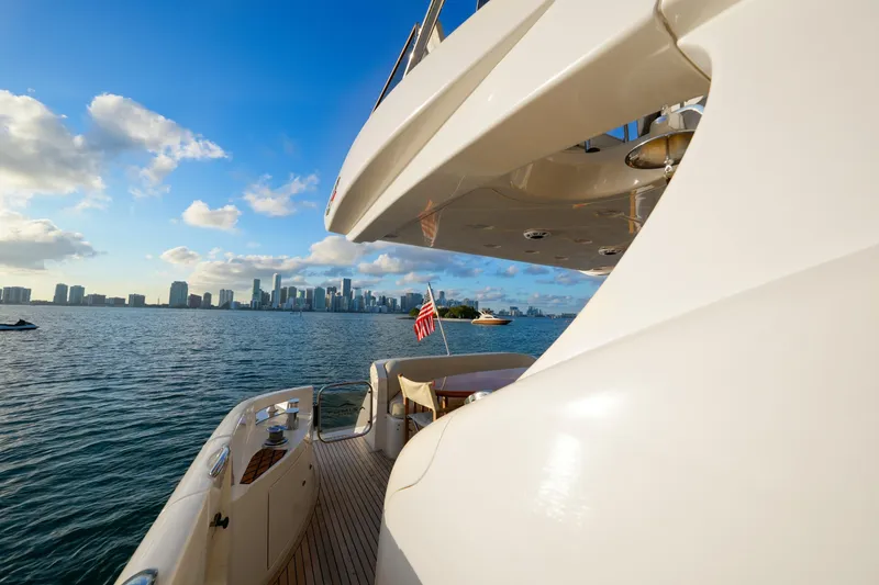 Slide: The Image of Luxury 2007 Azimut 68E yacht cruising near city skyline under blue sky. - 44