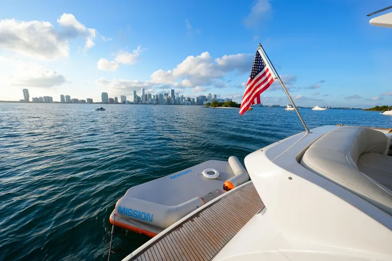 Slide: The Image of Luxury yacht Azimut 68E (2007) with city skyline and American flag in view. - 48