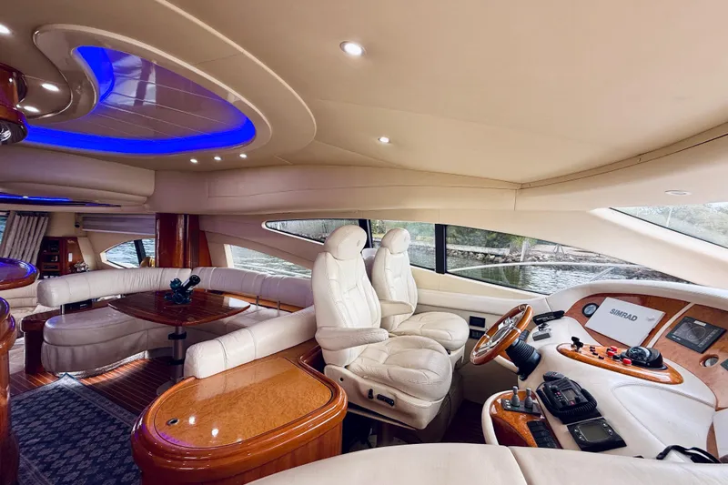 Slide: The Image of 2007 Azimut 68E yacht cruising near city skyline, wooden deck, clear sky. - 67