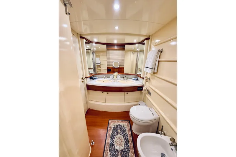 Slide: The Image of Luxurious 2007 Azimut 68E yacht with city skyline view, featuring elegant outdoor seating. - 78