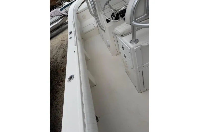 Slide: The Image of 2002 Regulator 26 Forward Seating boat interior with steering console and seating. - 10