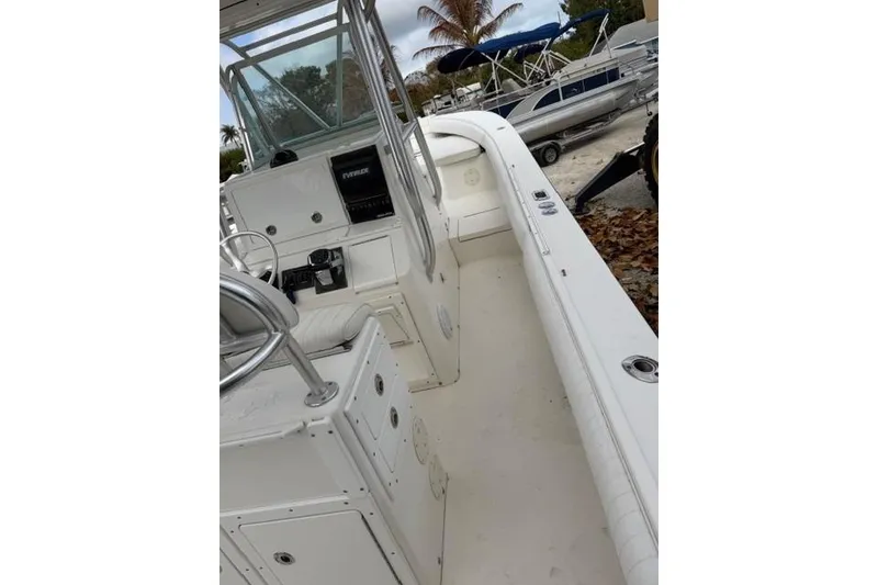 Slide: The Image of 2002 Regulator 26 Forward Seating boat interior with steering console and seating area. - 11