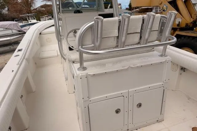 Slide: The Image of 2002 Regulator 26 Forward Seating boat interior with rod holders and storage compartments. - 12