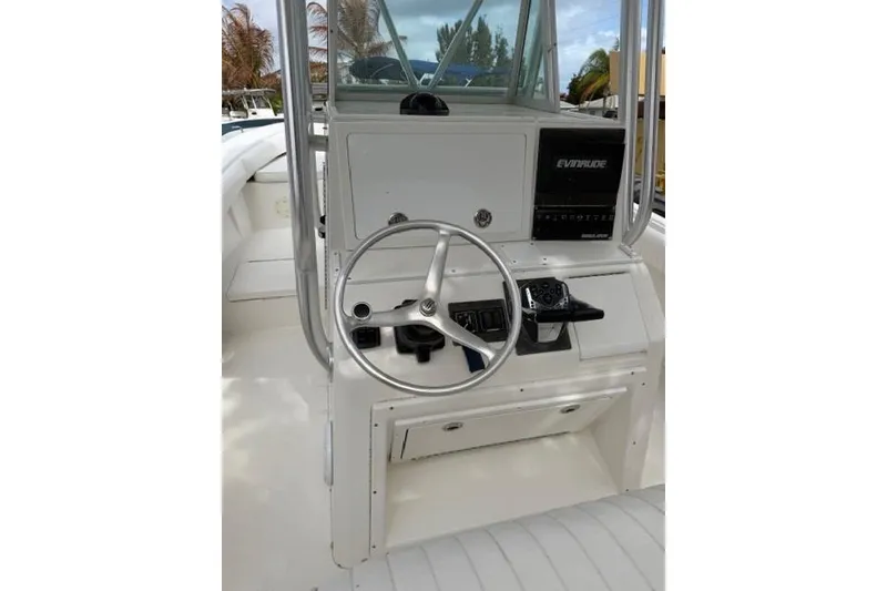 Slide: The Image of 2002 Regulator 26 Forward Seating boat console with steering wheel and controls. - 15