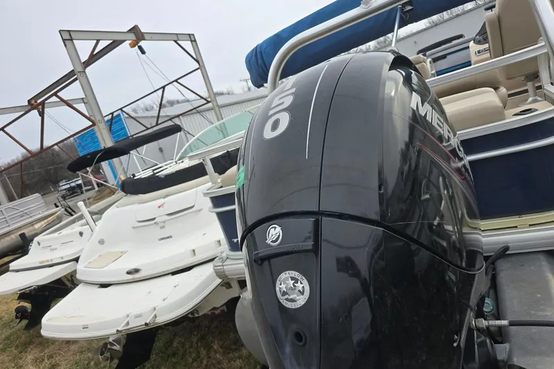 Slide: The Image of 2019 Sun Tracker Party Barge 22 Sport Fish with Mercury outboard motor, docked near other boats. - 4