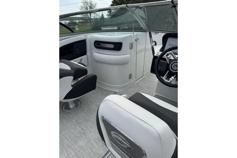 Slide: The Image of Interior of 2025 Crownline 250 XSS boat, featuring sleek seating and modern dashboard. - 10