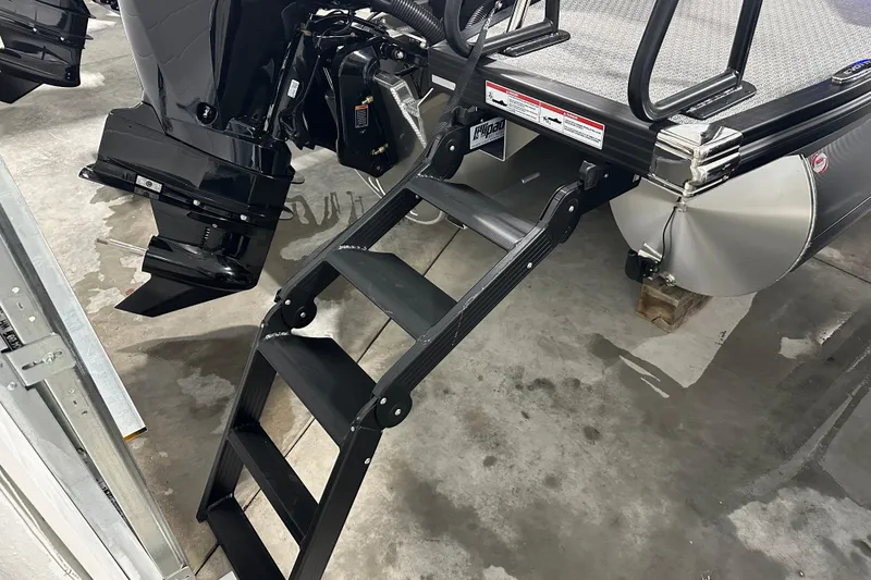 Slide: The Image of Evotti 523QL 2026 boat with ladder and motor in a garage setting. - 10