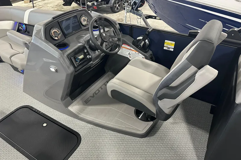 Slide: The Image of Captain's seat and dashboard of 2026 Evotti 523QL boat, featuring modern controls and design. - 3