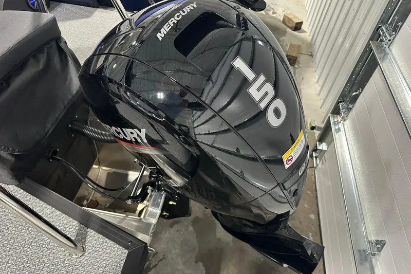 Slide: The Image of 2026 Evotti 523QL boat with Mercury 150 outboard motor in a garage setting. - 8