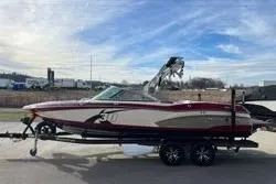 Slide: The Image of 2013 MasterCraft X30 boat on trailer under blue sky. - 10