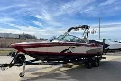 Slide: The Image of 2013 MasterCraft X30 boat on trailer under a clear blue sky. - 3