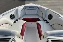 Slide: The Image of 2013 MasterCraft X30 boat interior with white and red seating, featuring built-in speakers. - 6