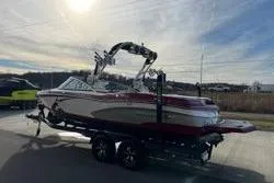 Slide: The Image of 2013 MasterCraft X30 boat on trailer under a bright sky. - 9
