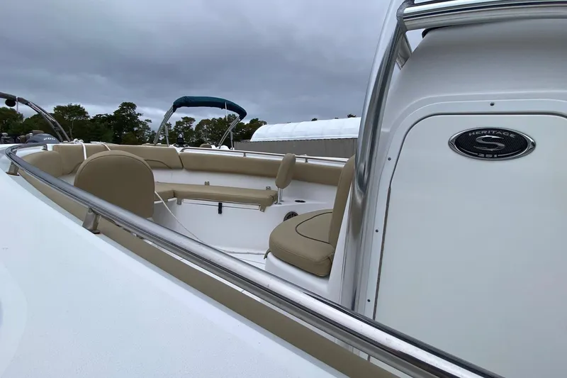 Slide: The Image of 2015 Sportsman Heritage 251 Center Console boat with beige seating and sleek design. - 10