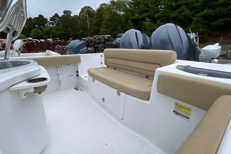 Slide: The Image of 2015 Sportsman Heritage 251 Center Console boat interior with seating and dual engines. - 11