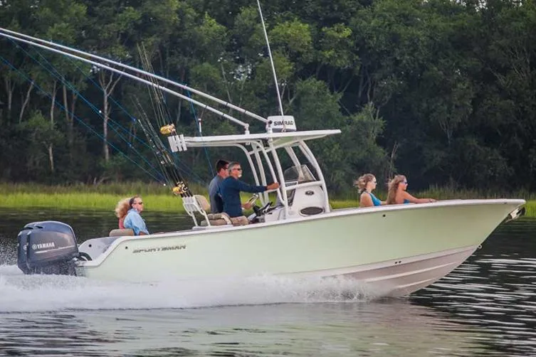 Slide: The Image of Manufacturer Provided Image: 2015 Sportsman Heritage 251 Center Console boat cruising on water with passengers. - 12