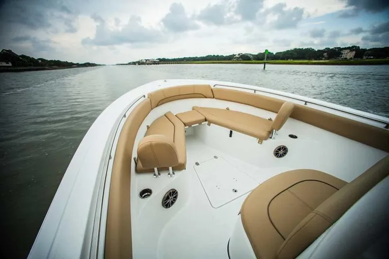 Slide: The Image of Manufacturer Provided Image: 2015 Sportsman Heritage 251 Center Console boat with tan seating on calm water. - 15