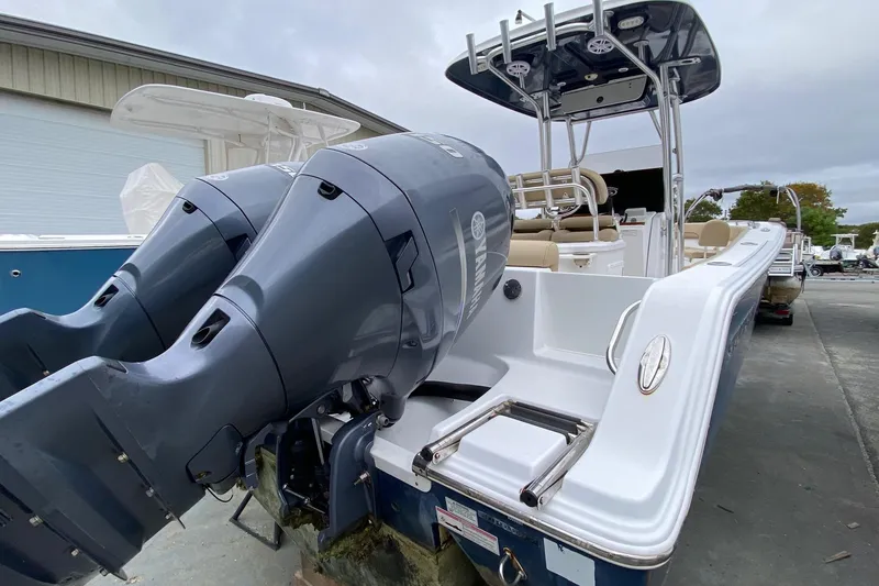 Slide: The Image of 2015 Sportsman Heritage 251 Center Console boat with dual outboard engines. - 2