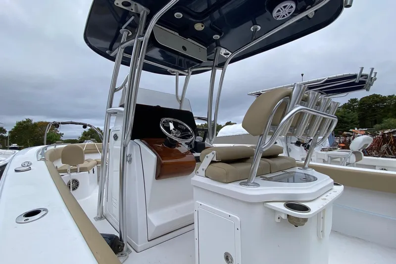 Slide: The Image of 2015 Sportsman Heritage 251 Center Console boat interior with steering and seating. - 5