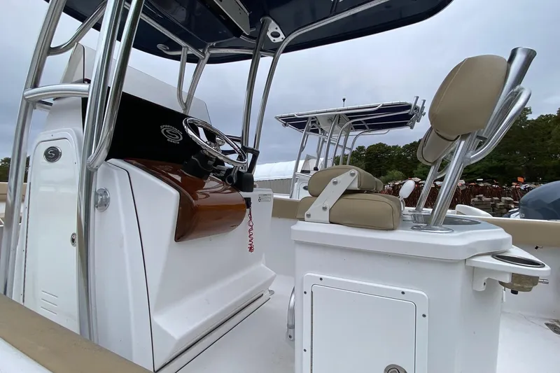 Slide: The Image of 2015 Sportsman Heritage 251 Center Console boat interior with steering wheel and seating. - 6