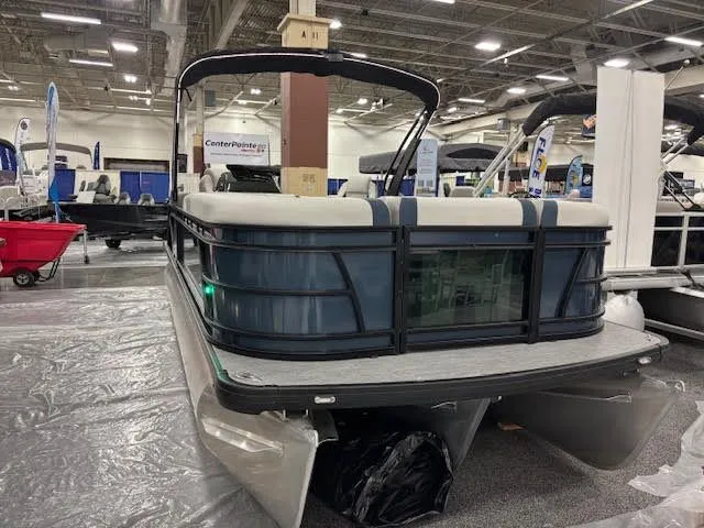 Slide: The Image of Godfrey SW2286SBC 2026 pontoon boat displayed at a trade show. - 1