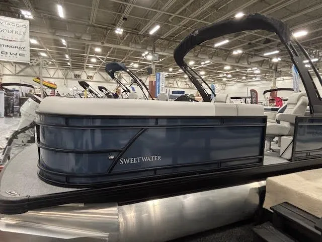 Slide: The Image of 2026 Godfrey SW2286SBC pontoon boat displayed at a show. - 3