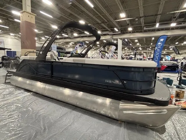 Slide: The Image of Godfrey Sweetwater pontoon boat 2026 displayed at a boat show. - 7