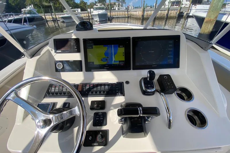 Slide: The Image of Control panel of 2015 Pursuit S 280 Sport boat with navigation screens and steering wheel. - 12
