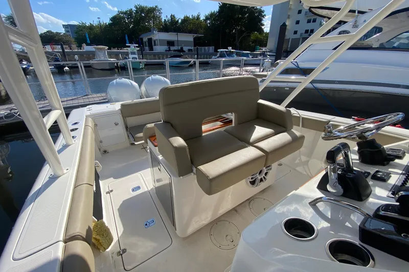 Slide: The Image of 2015 Pursuit S 280 Sport boat interior with seating and steering wheel at marina. - 14