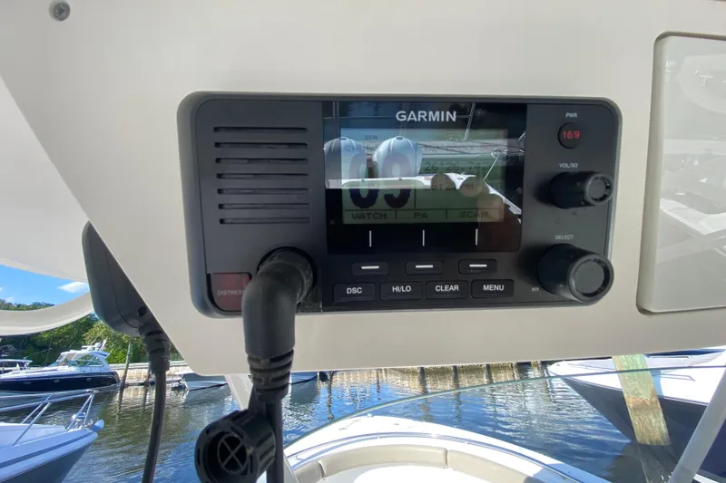 Slide: The Image of Garmin marine radio on 2015 Pursuit S 280 Sport boat, docked with other boats visible. - 17