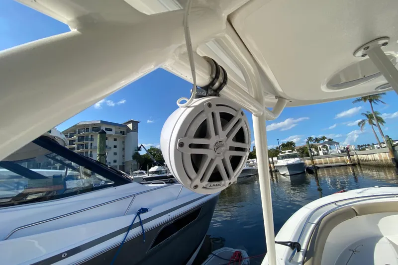 Slide: The Image of 2015 Pursuit S 280 Sport boat with JL Audio speaker, docked in sunny marina. - 18